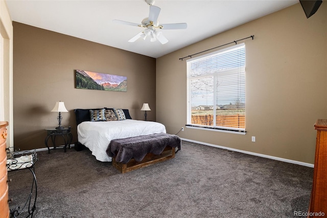 carpeted bedroom featuring baseboards and a ceiling fan