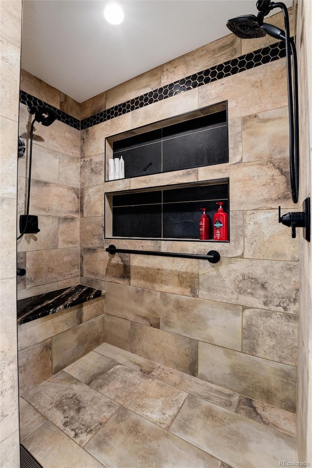 bathroom featuring a tile shower and recessed lighting