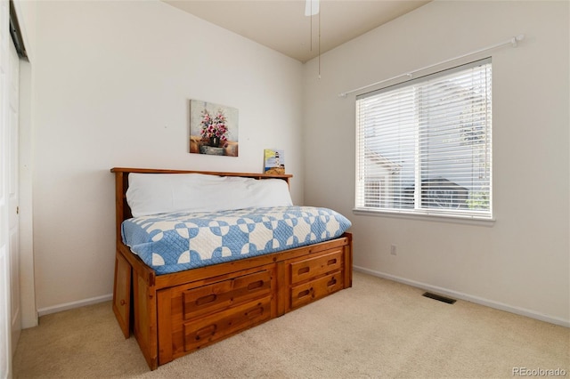 bedroom featuring light colored carpet, multiple windows, and baseboards
