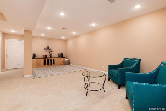 sitting room featuring light carpet, recessed lighting, and baseboards