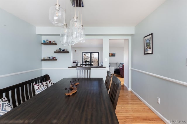 dining space with light hardwood / wood-style flooring