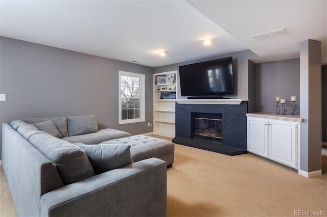 carpeted living room featuring a brick fireplace