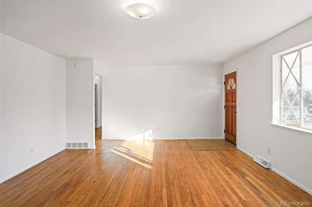 spare room with light wood-type flooring