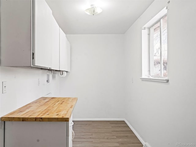 clothes washing area featuring wood-type flooring