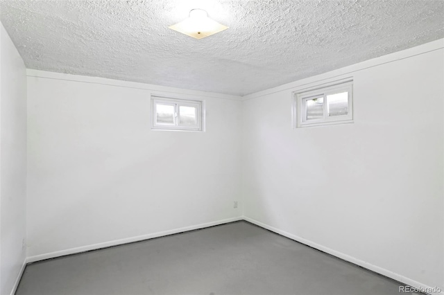 basement with plenty of natural light and a textured ceiling