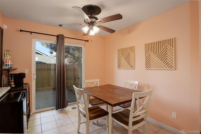 dining area featuring light tile patterned floors, baseboards, and ceiling fan