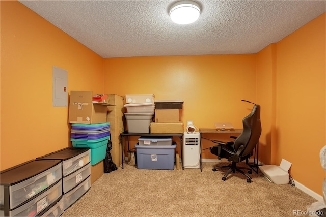 carpeted office with electric panel, baseboards, and a textured ceiling