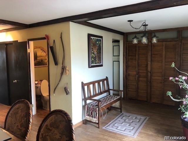 interior space featuring hardwood / wood-style floors and beamed ceiling