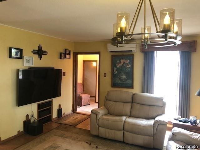 living room featuring an inviting chandelier and a wall mounted AC