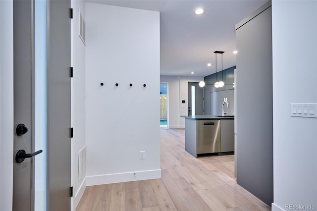 hall featuring light hardwood / wood-style floors and sink