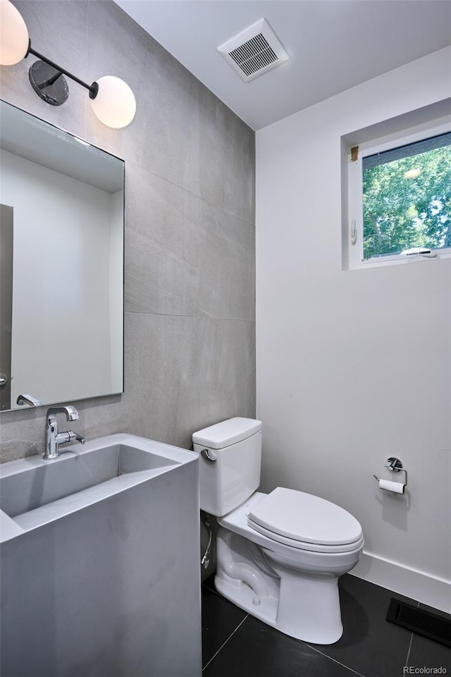 bathroom featuring tile patterned flooring, vanity, and toilet