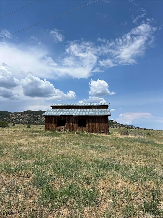 view of outdoor structure with a rural view