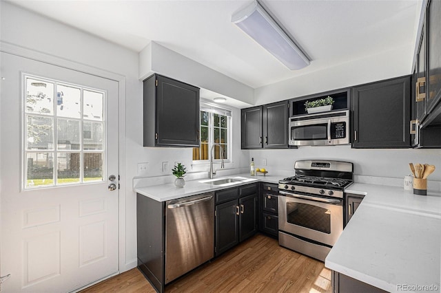 6774 S Independence St, Littleton, CO 80128 - kitchen with appliances with stainless steel finishes, open shelves, healthy amount of natural light, and light wood finished floors