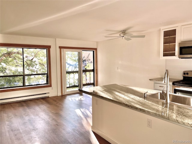 827 Maxwell Ave Unit H, Boulder, CO 80304 - kitchen with stainless steel appliances, ceiling fan, light stone counters, dark wood finished floors, and a baseboard heating unit