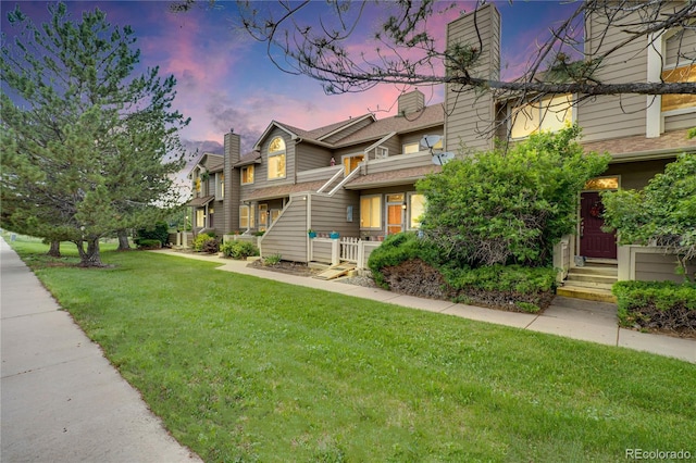 1099 S Walden Way Unit 205, Aurora, CO 80017 - view of front of home featuring a chimney and a front yard