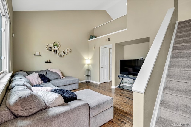 1099 S Walden Way Unit 205, Aurora, CO 80017 - living area with wood finished floors, stairs, and high vaulted ceiling