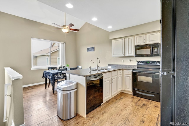1099 S Walden Way Unit 205, Aurora, CO 80017 - kitchen featuring black appliances, a peninsula, light wood-type flooring, lofted ceiling, and a ceiling fan