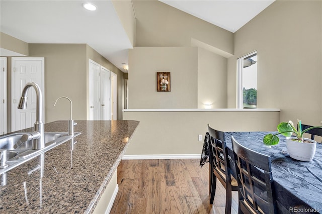 1099 S Walden Way Unit 205, Aurora, CO 80017 - kitchen featuring wood finished floors and dark stone countertops