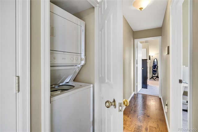 1099 S Walden Way Unit 205, Aurora, CO 80017 - washroom with stacked washer and clothes dryer and wood finished floors