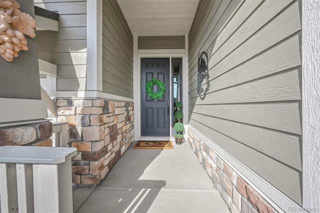 doorway to property featuring stone siding