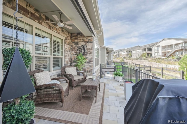 balcony featuring a residential view, a grill, and ceiling fan