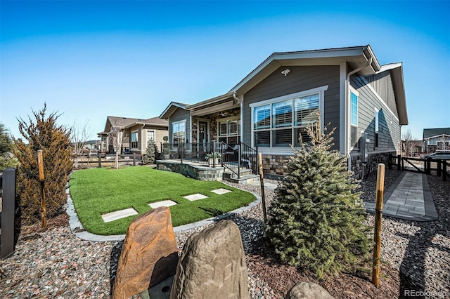 rear view of property with a yard and fence