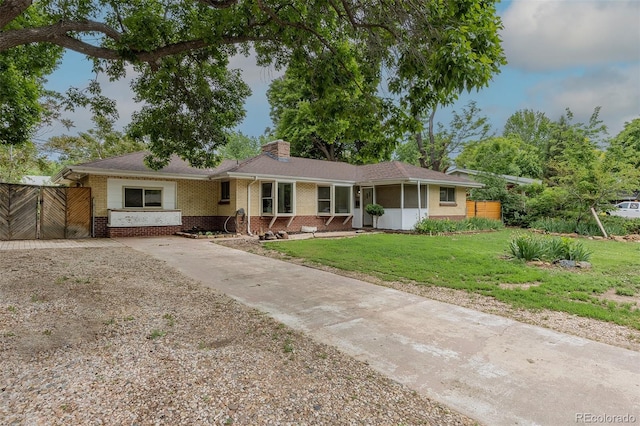 5810 S Greenwood St, Littleton, CO 80120 - single story home featuring brick siding, a chimney, and concrete driveway