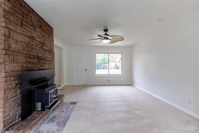 5810 S Greenwood St, Littleton, CO 80120 - unfurnished living room with a wood stove, a ceiling fan, carpet flooring, and baseboards