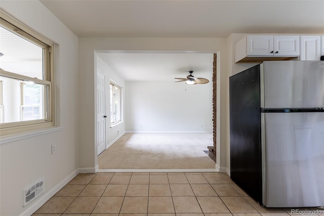 5810 S Greenwood St, Littleton, CO 80120 - kitchen with freestanding refrigerator, light carpet, a ceiling fan, white cabinetry, and light tile patterned flooring