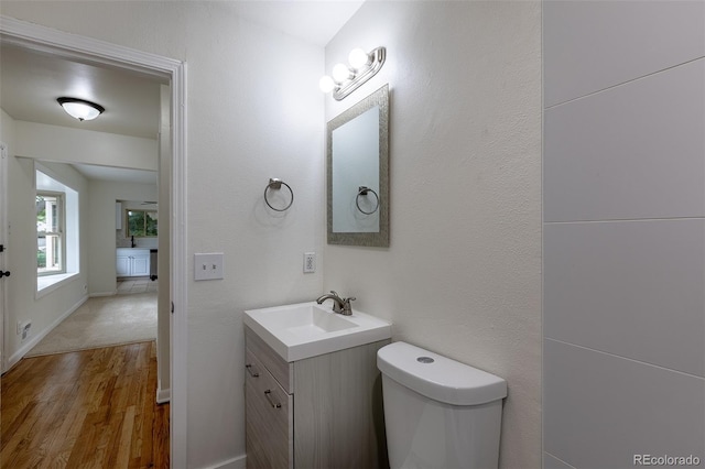 5810 S Greenwood St, Littleton, CO 80120 - bathroom with vanity, toilet, wood finished floors, and baseboards