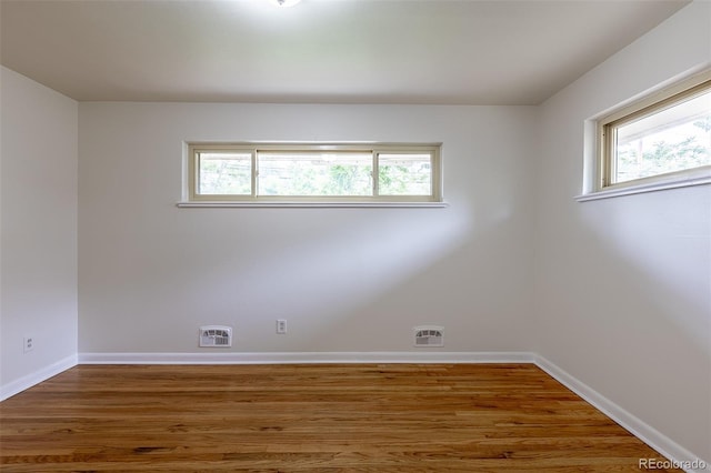5810 S Greenwood St, Littleton, CO 80120 - empty room featuring plenty of natural light, baseboards, and wood finished floors