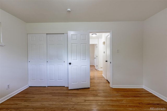 5810 S Greenwood St, Littleton, CO 80120 - unfurnished bedroom with baseboards, wood finished floors, and a closet