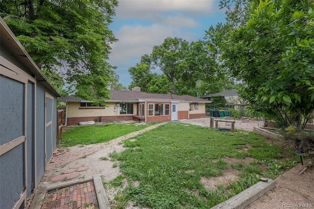 5810 S Greenwood St, Littleton, CO 80120 - back of house featuring brick siding and a chimney