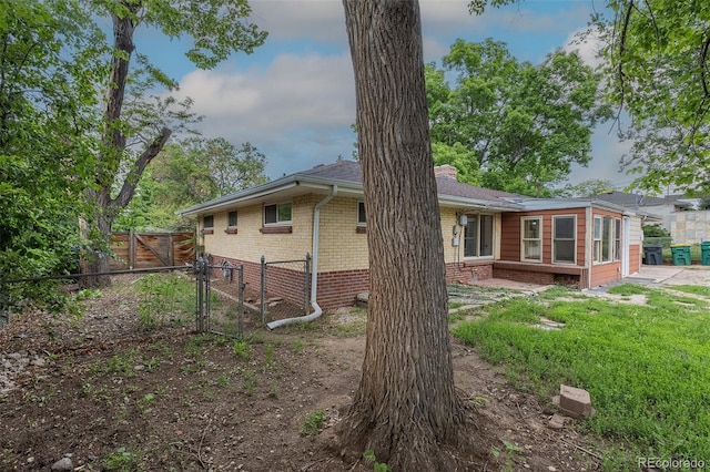 5810 S Greenwood St, Littleton, CO 80120 - rear view of property with brick siding and a chimney