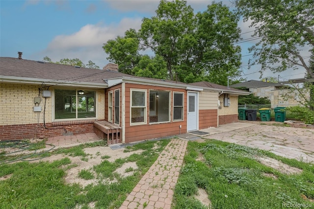 5810 S Greenwood St, Littleton, CO 80120 - back of house featuring a patio area, brick siding, and a chimney