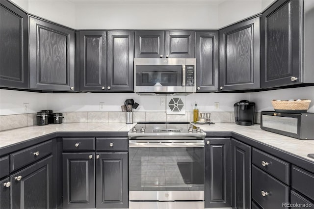 6888 Howell St, Arvada, CO 80004 - kitchen featuring stainless steel appliances and light countertops