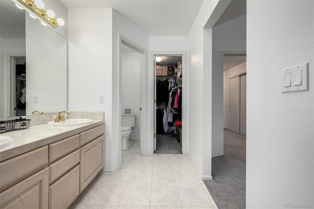 6888 Howell St, Arvada, CO 80004 - bathroom with a walk in closet and double vanity