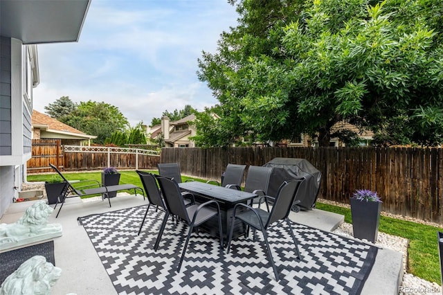 6888 Howell St, Arvada, CO 80004 - fenced backyard featuring outdoor dining area, a patio area, and grilling area