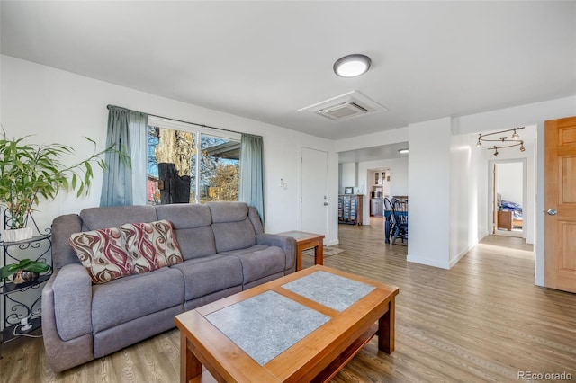 living room with hardwood / wood-style flooring and a notable chandelier