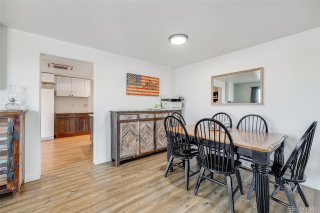 dining space with light hardwood / wood-style flooring