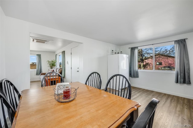 dining space with light wood-type flooring