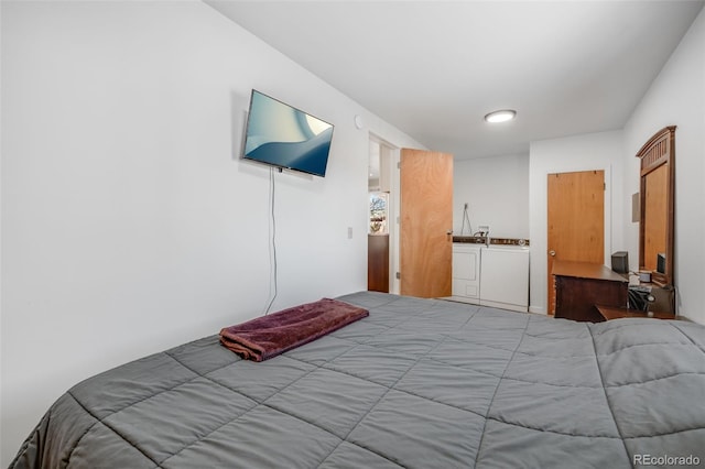 bedroom with washing machine and dryer