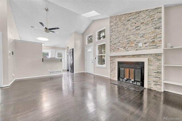 1148 S Ventura Cir Unit H, Aurora, CO 80017 - unfurnished living room featuring a ceiling fan, a textured ceiling, dark wood-style flooring, baseboards, and vaulted ceiling