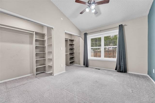 1148 S Ventura Cir Unit H, Aurora, CO 80017 - unfurnished bedroom featuring carpet, a textured ceiling, lofted ceiling, multiple closets, and a ceiling fan