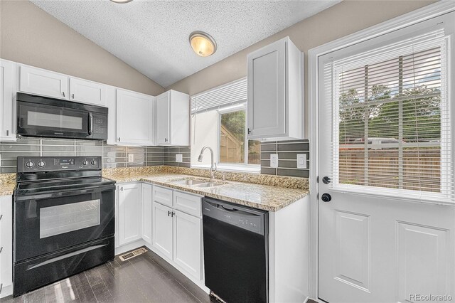 1148 S Ventura Cir Unit H, Aurora, CO 80017 - kitchen with black appliances, a sink, vaulted ceiling, a textured ceiling, and white cabinets