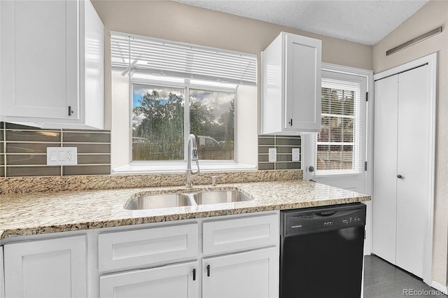 1148 S Ventura Cir Unit H, Aurora, CO 80017 - kitchen featuring black dishwasher, a sink, white cabinetry, and a textured ceiling