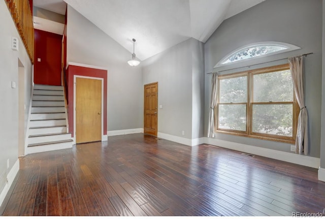 10525 Hobbit Ln, Westminster, CO 80031 - unfurnished living room with high vaulted ceiling, hardwood / wood-style flooring, and stairs