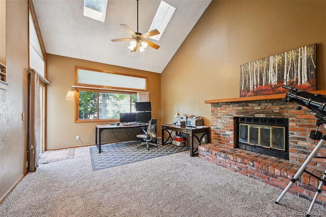 10525 Hobbit Ln, Westminster, CO 80031 - carpeted home office featuring high vaulted ceiling, a brick fireplace, a ceiling fan, and a skylight