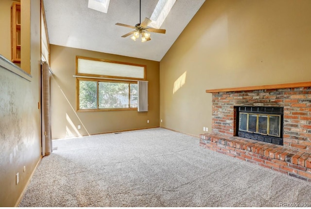 10525 Hobbit Ln, Westminster, CO 80031 - unfurnished living room featuring a skylight, carpet floors, a brick fireplace, high vaulted ceiling, and a ceiling fan