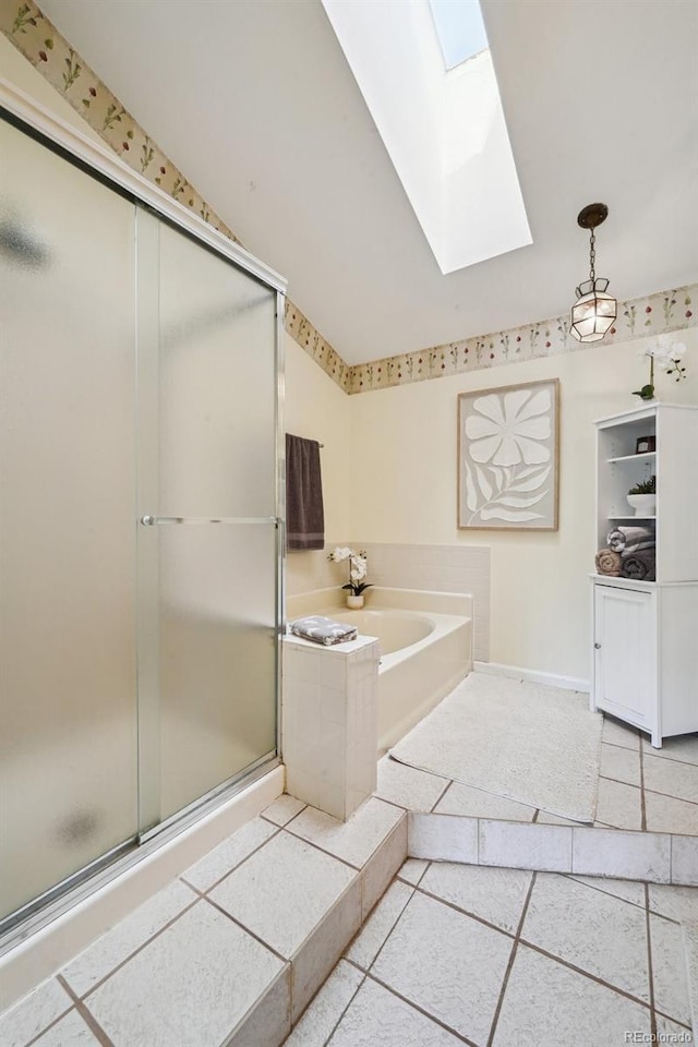 10525 Hobbit Ln, Westminster, CO 80031 - bathroom featuring a skylight, a bath, a shower stall, and tile patterned flooring